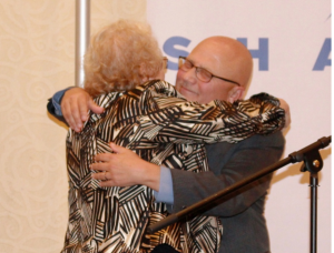 Ruth Hollman hugs honoree Allen Berger.